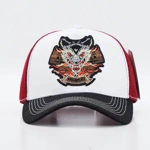 Close-up of wolf head embroidery on white and red mesh trucker baseball cap