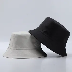 Detail view of reinforced stitching on brim of black and beige minimalist bucket hats