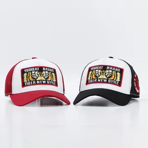 Detail of premium tiger embroidery on breathable mesh trucker hat with side badges