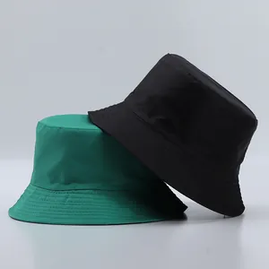 Detail of reinforced stitching on brim and texture of black and green bucket hats