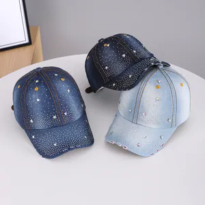 Detailed view of three washed denim baseball caps with rhinestones and star patterns
