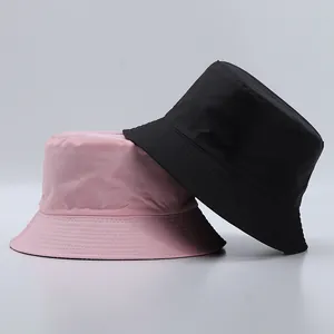 Minimalist pink and black fisherman buckets hats in durable synthetic fabric