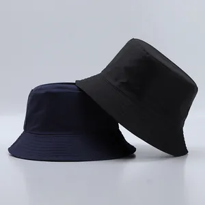Detailed stitching and fabric texture on dark blue and black nylon bucket hats