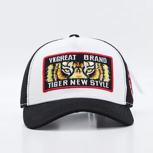 Close-up of intricate tiger eye embroidery and mesh texture on a trucker baseball cap