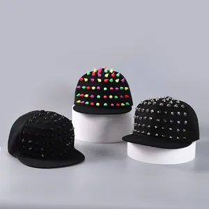 Detail of street style snapback hats featuring colorful punk rivets and metallic studs