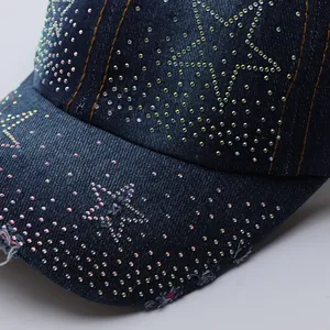 Detail of blue denim baseball cap with sparkling rhinestones and vintage frayed brim