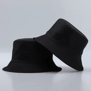 Detailed view of black bucket hat showing rows of stitching on the brim and fabric texture