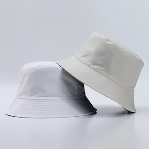 Detail of minimalist bucket hats showing fine grid texture and stitched brim in neutral tones