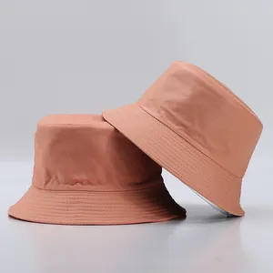 Detail view of salmon pink bucket hats featuring reinforced stitching on the brim