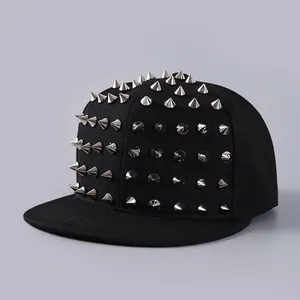 Detailed close-up of metallic silver studs on a black flat-brimmed streetwear baseball cap