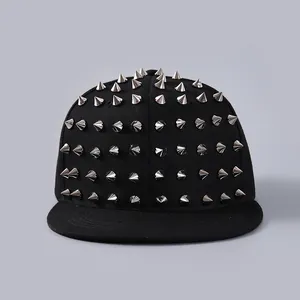 Close-up of black flat brim baseball cap featuring rows of sharp silver metal punk studs
