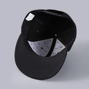 Detail view of the black snapback cap interior showing 80% cotton 20% polyester label