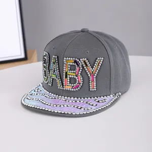 Detailed view of colorful rhinestones on a grey snapback hat with laser holographic brim