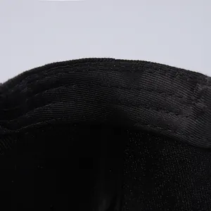Detail view of reinforced inner sweatband stitching on a black flat-brim baseball cap