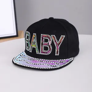 Detail of black hip-hop cap with colorful rhinestone BABY text and shiny purple flat brim