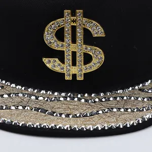 Macro detail of rhinestones on gold dollar sign and sequined brim of hip-hop snapback hat