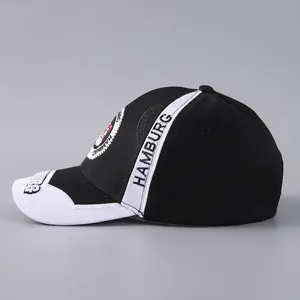 Detail view of Hamburg city crest embroidery on black and white cotton baseball cap