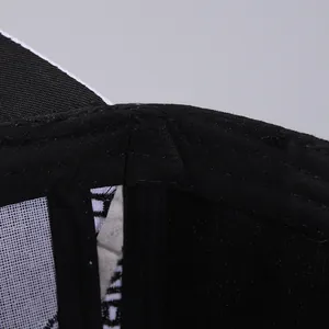 Detailed close-up of the double stitching and internal mesh support on a black baseball cap