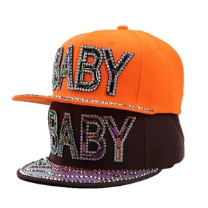 Flat brim snapback hats with rhinestone BABY lettering in vibrant orange and deep brown colors