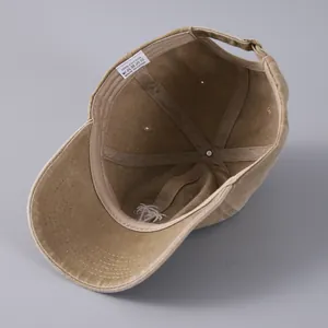 Inside view of khaki embroidered cotton baseball cap showing stitching and sweatband