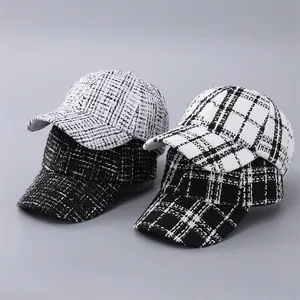 Close-up of four houndstooth and windowpane check tweed baseball caps for winter