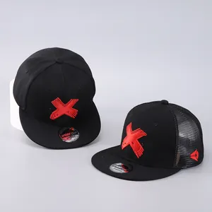 Detail of black snapback caps with red X embroidery and breathable mesh back design