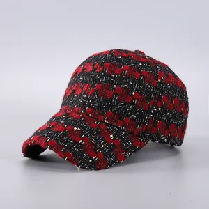 Detail of red and black houndstooth tweed baseball cap with subtle gold sequins