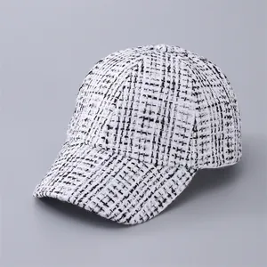 Macro detail of high-quality black and white houndstooth tweed texture on a baseball cap
