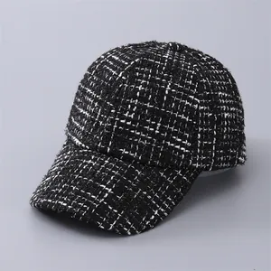 Close-up detail of the black and white houndstooth tweed texture on this baseball cap