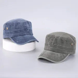 Detail of vintage washed cotton flat top military caps in navy blue and olive green colors