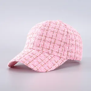 Detailed view of pink tweed baseball cap featuring subtle gold metallic thread accents
