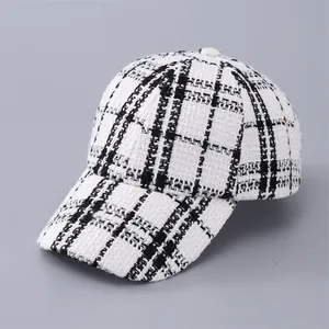 Close-up of black and white houndstooth pattern and tweed texture on baseball cap
