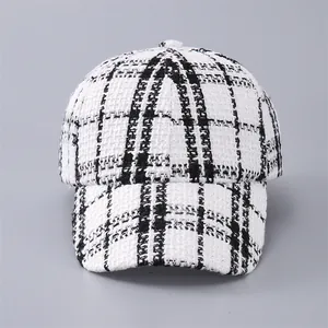 Close-up of black and white houndstooth tweed texture on a vintage baseball cap