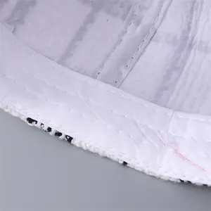 Macro shot showing high-quality stitching on the white lining of a houndstooth baseball cap