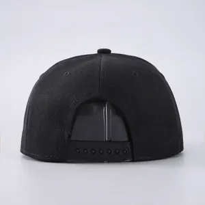 Detail view of the black snapback cap showing adjustable plastic strap and ventilation eyelets
