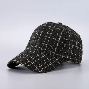 Side view of luxury black and gold tweed baseball cap with textured woven fabric