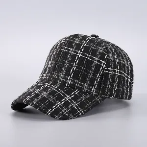 Macro detail of black and white houndstooth tweed texture on stylish baseball cap