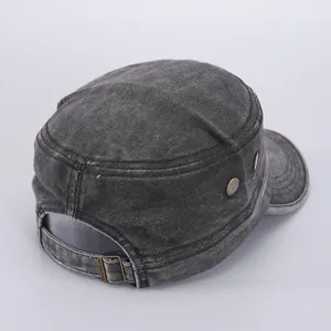Detail of adjustable metal buckle and breathable side vents on washed denim military cap