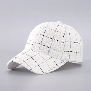 Close-up of premium tweed baseball cap with black and gold plaid texture detail