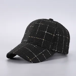 Macro detail of houndstooth baseball cap in black tweed with gold and silver metallic threads