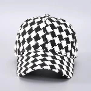 Detailed view of the woven houndstooth pattern and texture on a stylish baseball cap
