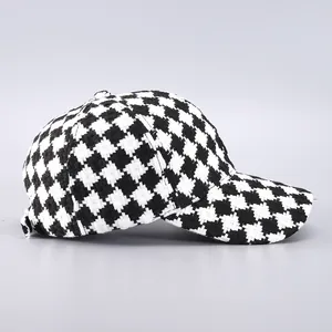 Close-up of black and white houndstooth tweed texture on a baseball cap crown