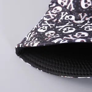 Detail of a black bucket hat with skull prints and neat parallel stitching on the brim