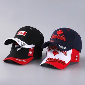 Close-up of Canada maple leaf embroidery on assorted cotton baseball caps in various colors