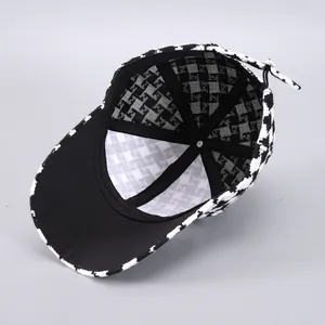 Detail shot of houndstooth baseball cap featuring FF pattern lining and adjustable strap