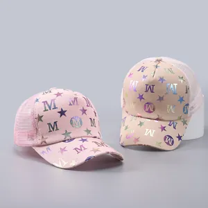 Detail of pink and beige mesh baseball caps with holographic M and star patterns