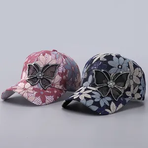 Close-up of floral lace baseball caps with rhinestone butterfly and mesh details