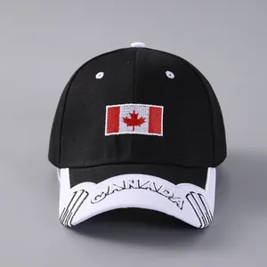 Detailed close-up of embroidered Canada maple leaf flag and white letters on a black cap