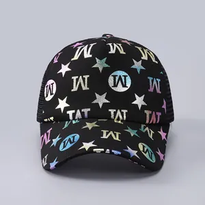 Detail of black mesh trucker hat featuring holographic stars and iridescent M TAT letters