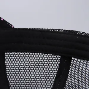 Detail of breathable black mesh fabric and purple sequin accents on a baseball cap